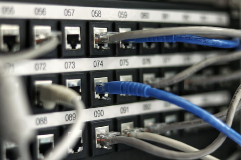 Ethernet patch panel with blue and grey cables showing wired segments that affect Malaysia home fibre speed tests